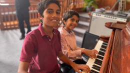 Two brothers sitting at a grand piano during Lifelong Music School's annual recital in Hunterdon County, NJ Two brothers sitting at a grand piano during Lifelong Music School's annual recital in Hunterdon County, NJ